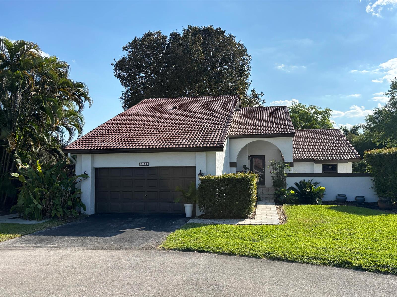 A single-story house with a brown tile roof, white stucco walls, and a two-car garage — 2199 Charleston, Weston FL 33326, WESTON, FL