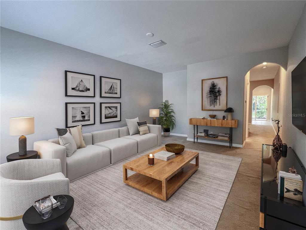 A living room features a light-colored sectional sofa, a wooden coffee table, and framed artwork — 267 CAPE HARBOUR LOOP UNIT 103, BRADENTON, FL