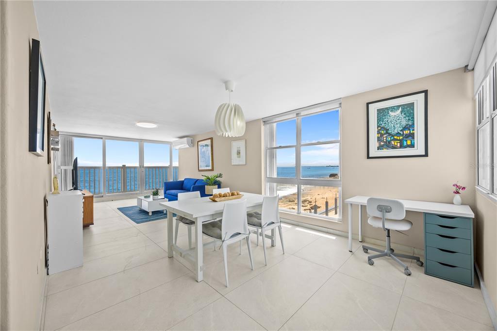 A bright living and dining area with tile floors, white furniture, and ocean views — 1035 AVE ASHFORD UNIT 302, SAN JUAN, PR