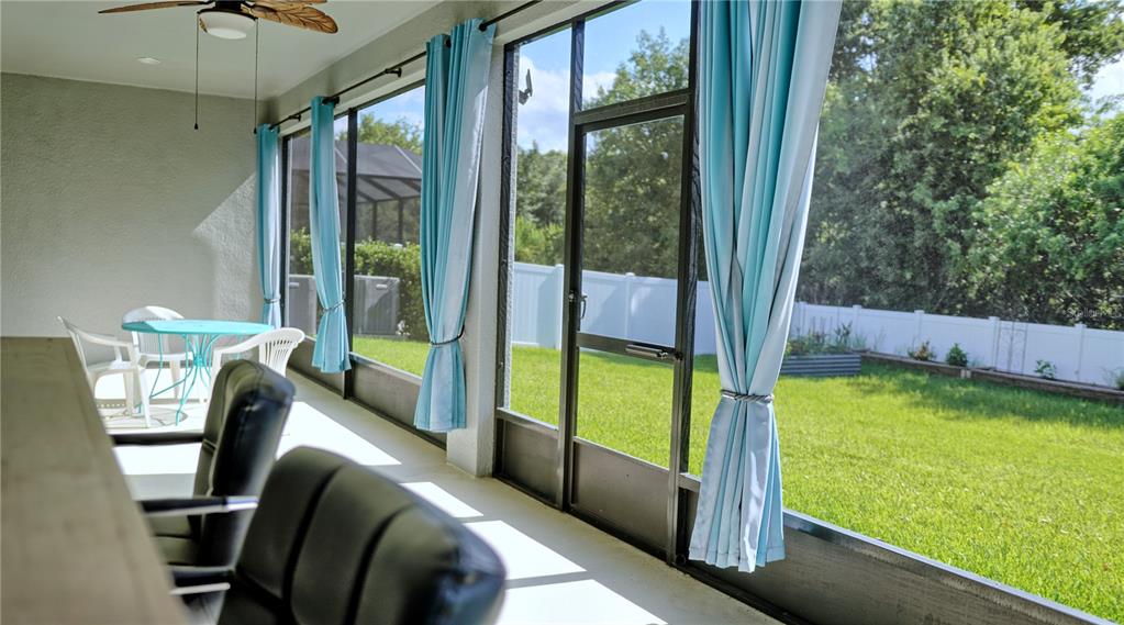 An aerial view shows a two-story house with solar panels on the roof and a backyard — 11608 DUBLIN GRAFTON DRIVE, RIVERVIEW, FL
