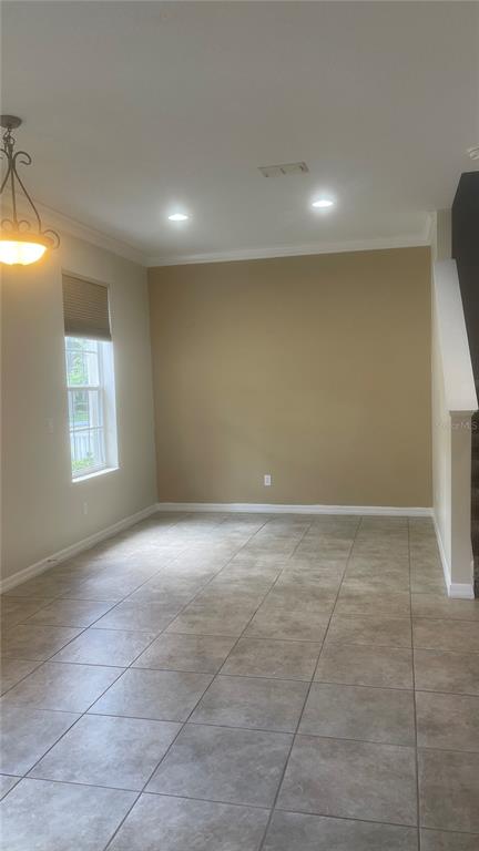 An empty room with tan walls, tile flooring, a window with blinds, and recessed lighting — 1918 SWEET BIRCH LANE, ORLANDO, FL