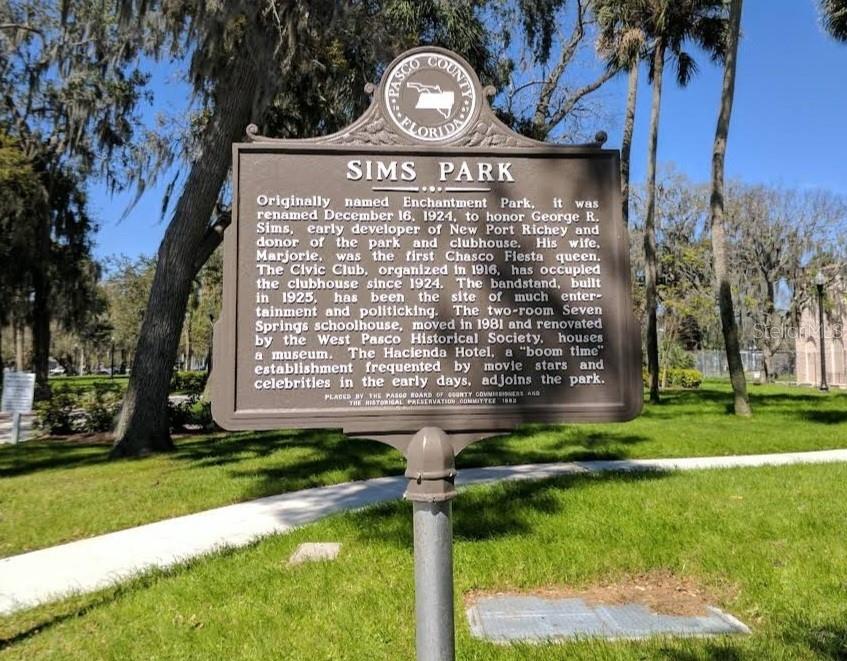 A historical marker for Sims Park stands in a grassy area with trees in the background — 6313 OELSNER STREET, NEW PORT RICHEY, FL