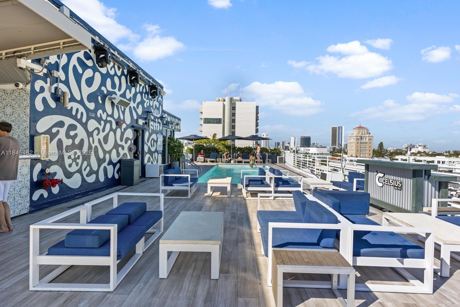 A rooftop terrace features a swimming pool, blue lounge seating, and a patterned mural wall — 1024 Ocean Dr # A207, Miami Beach FL 33139, MIAMI BEACH, FL