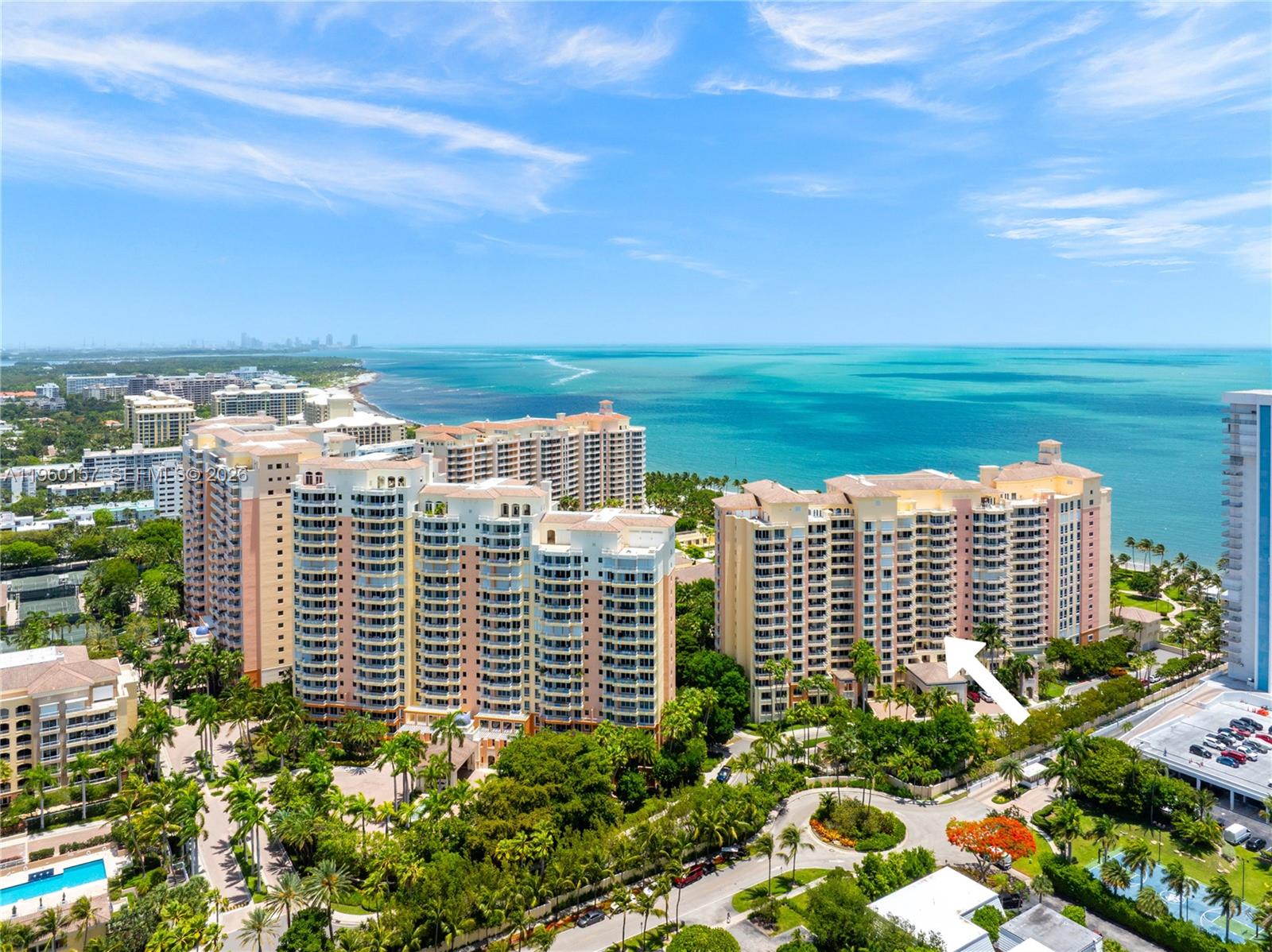 An aerial view shows multiple high-rise residential buildings surrounded by lush landscaping near the ocean — 799 Crandon Blvd # 605, Key Biscayne FL 33149, KEY BISCAYNE, FL