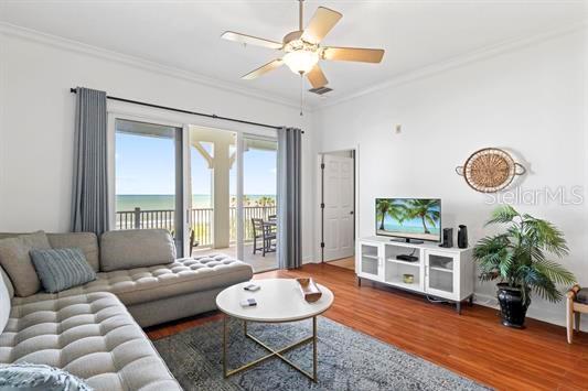 A living room features a gray sectional sofa, a coffee table, and a balcony view — 700 CINNAMON BEACH WAY UNIT 633, PALM COAST, FL