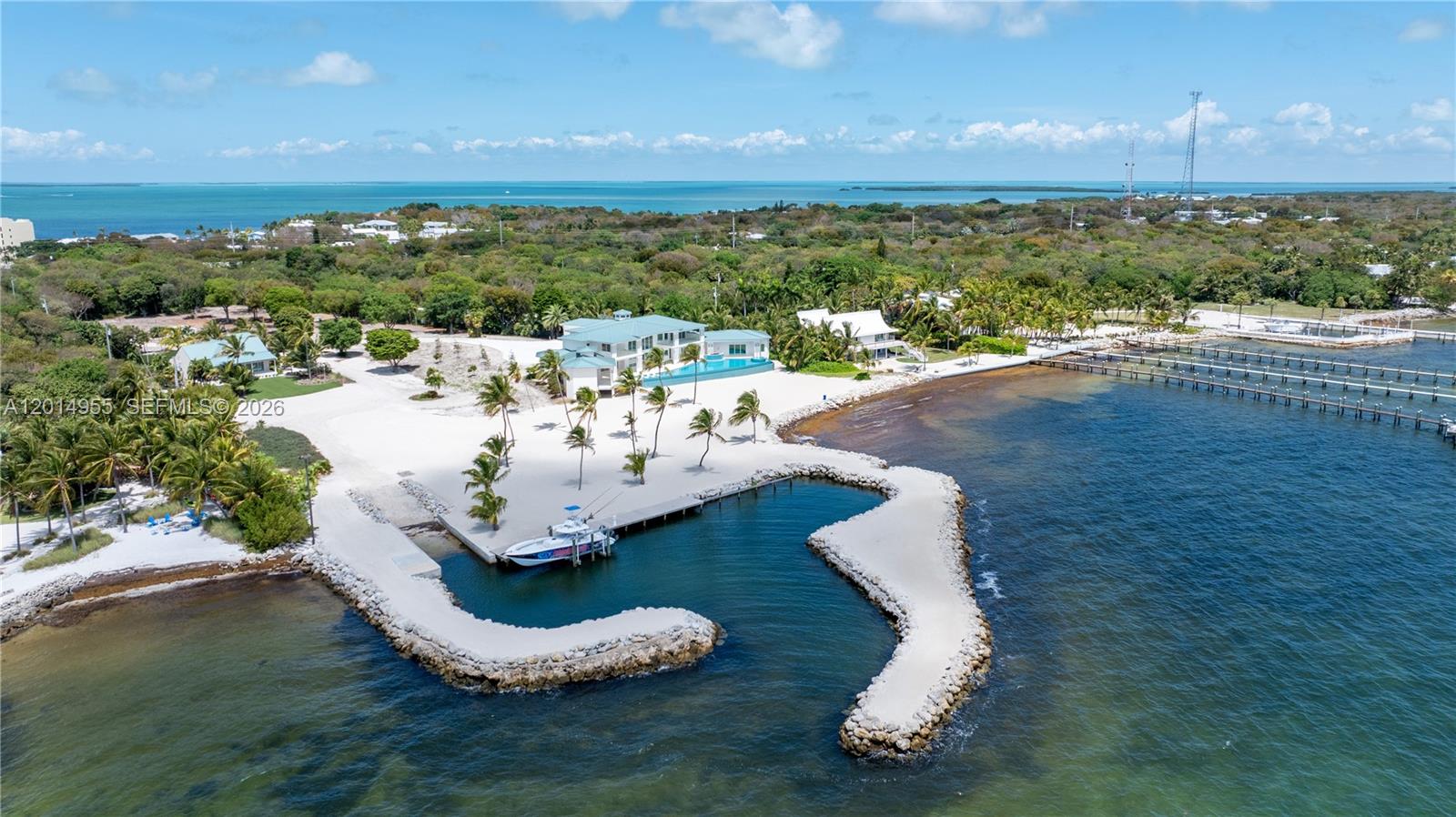 An aerial view shows a waterfront estate with a private boat basin and sandy beach — 88845 Old Hwy, Tavernier FL 33070, TAVERNIER, FL