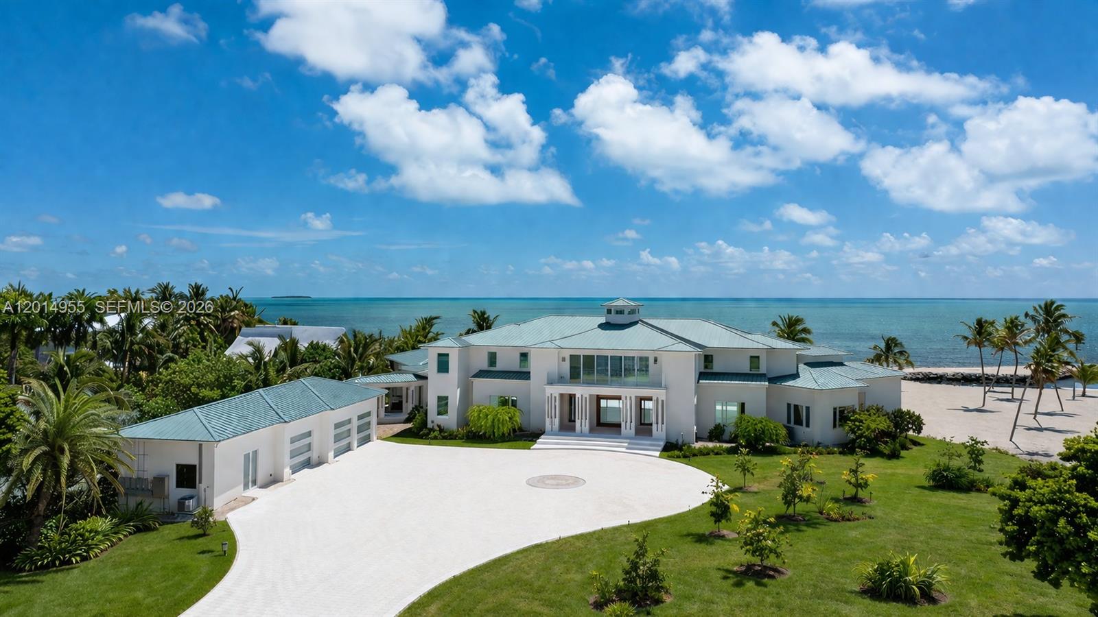 An aerial view shows a large white waterfront house with a green metal roof — 88845 Old Hwy, Tavernier FL 33070, TAVERNIER, FL