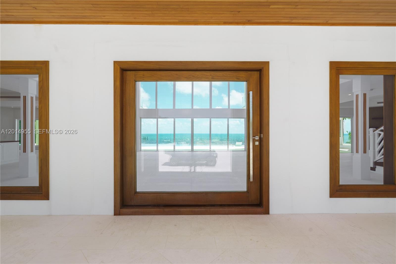 A large wooden door with a glass pane sits between two matching side windows — 88845 Old Hwy, Tavernier FL 33070, TAVERNIER, FL