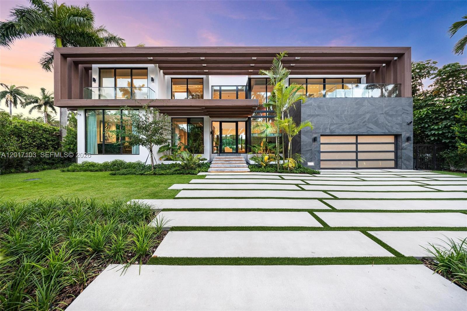 A modern two-story house features a concrete paver driveway, wood-slat roof accents, and stone siding — 2520 Shelter Ave, Miami Beach FL 33140, MIAMI BEACH, FL