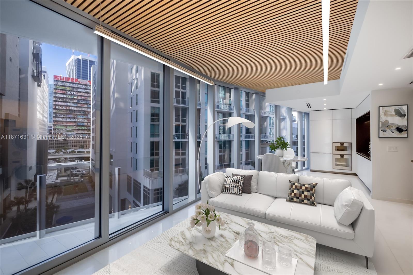A modern living room with floor-to-ceiling windows, a slatted wood ceiling, and white furniture — 300 Biscayne Blvd Way # 506E, Miami FL 33131, MIAMI, FL