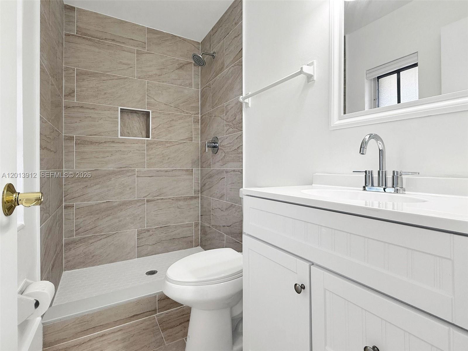 A bathroom features a tiled walk-in shower, a white vanity, and a toilet — 3045 SW 124th Ct, Miami FL 33175, MIAMI, FL