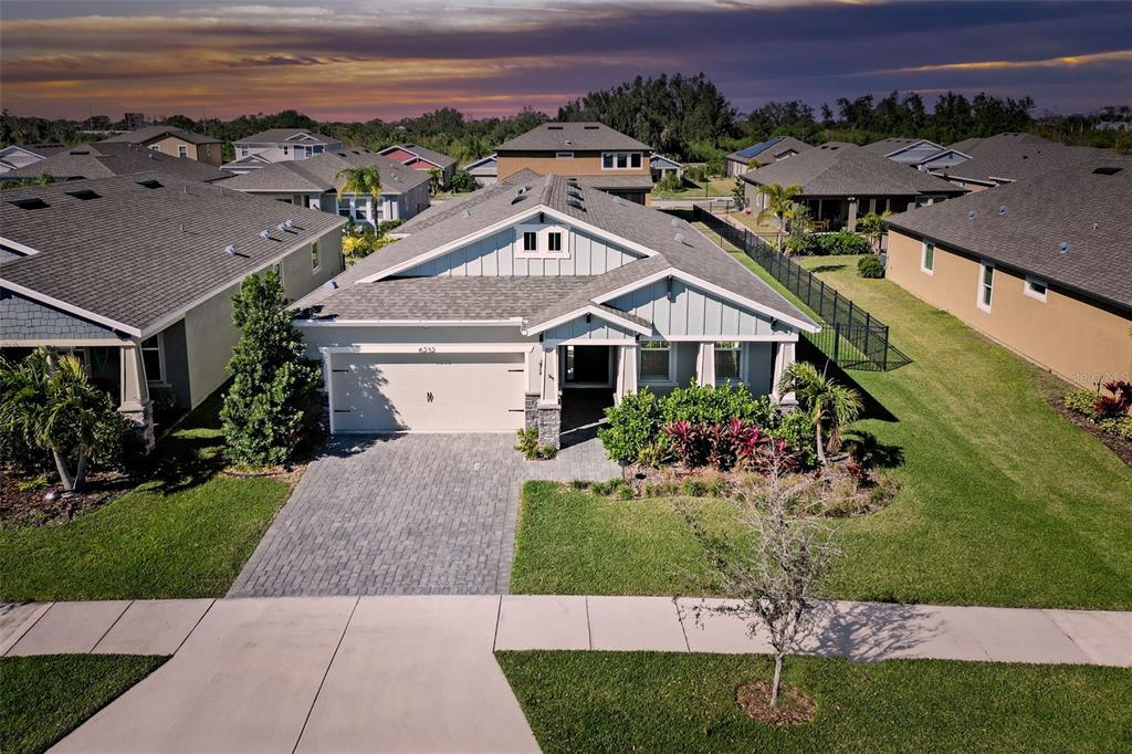 An aerial view of a single-story suburban house with a paved driveway and gray roof — 6232 SEA AIR DRIVE, APOLLO BEACH, FL