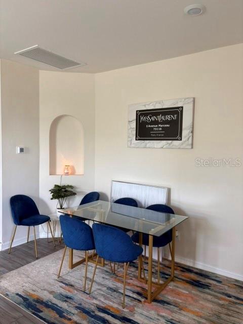 A dining area features a glass table with four blue velvet chairs on a rug — 2119 NW 23RD TERRACE, CAPE CORAL, FL