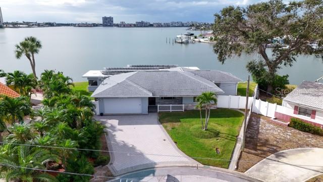 An aerial view of a waterfront house with a paved driveway and a grassy yard — 7800 4TH AVENUE S, ST PETERSBURG, FL