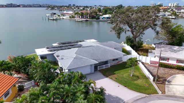 An aerial view shows a house with solar panels on the roof near a bay — 7800 4TH AVENUE S, ST PETERSBURG, FL