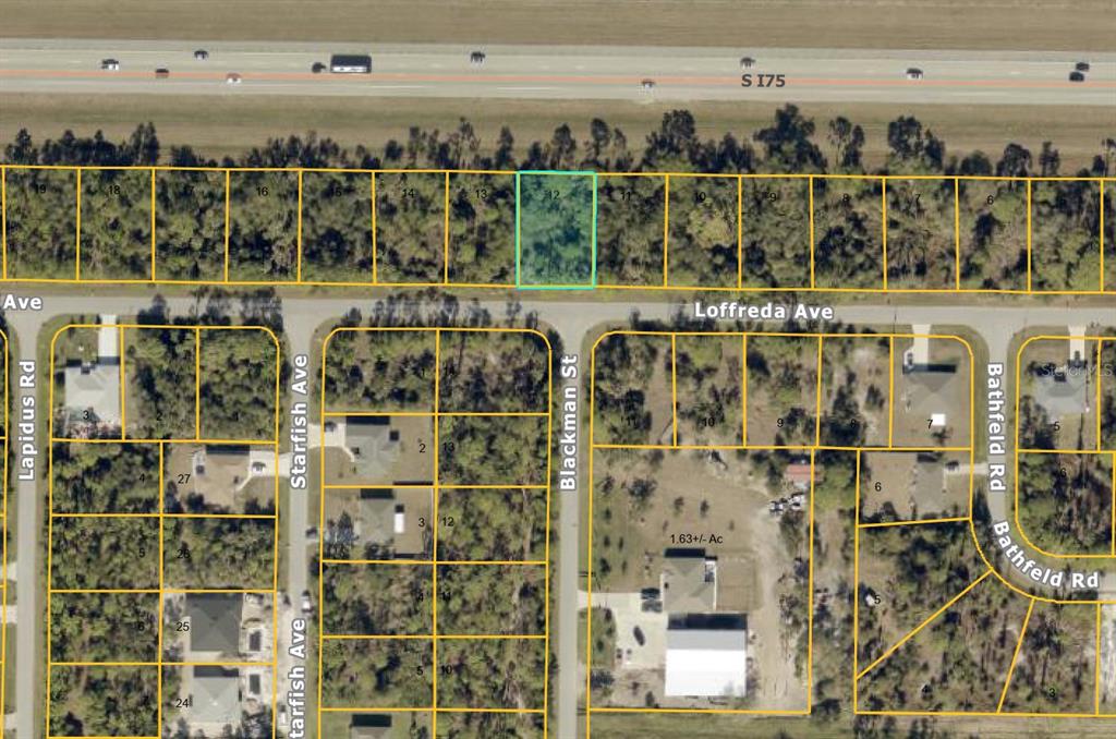 This is an aerial map showing a highlighted vacant lot located along a highway — LOFFREDA AVENUE, NORTH PORT, FL