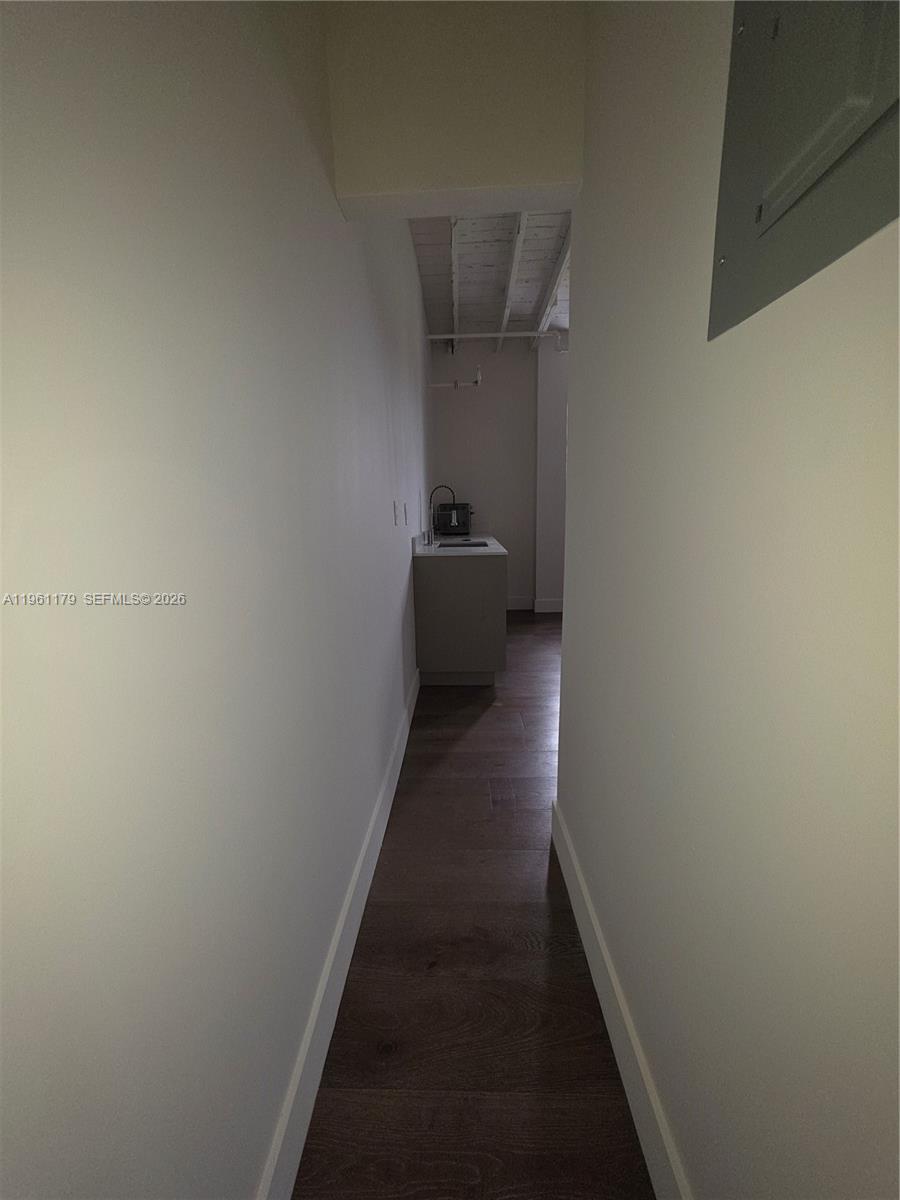 A narrow hallway leads to a small kitchenette with a sink and dark wood flooring — 164 NW 20th St # 202, Miami FL 33127, MIAMI, FL