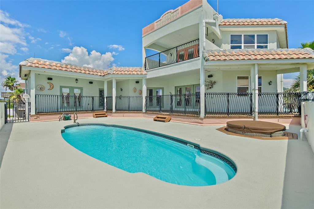 A two-story house with a swimming pool, hot tub, and fenced patio area — 54 OCEAN ST, PALM COAST, FL