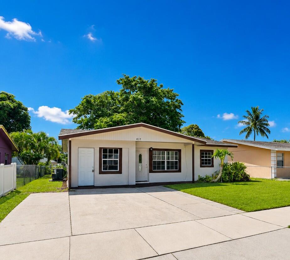A single-story house with a white exterior, brown trim, and a concrete driveway — 417 SW 8th Avenue, Delray Beach FL 33444, DELRAY BEACH, FL