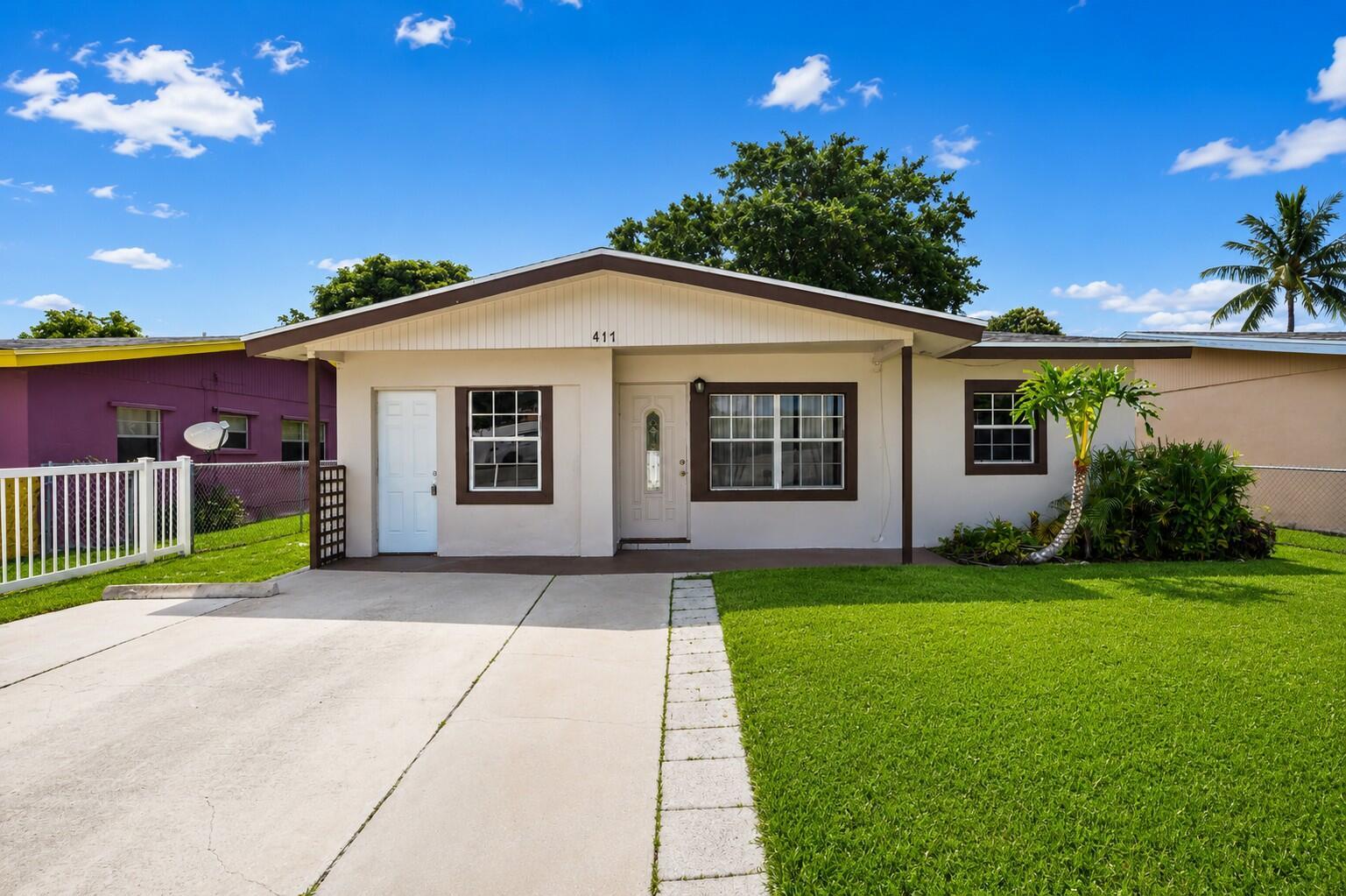 A single-story house with a white exterior, brown trim, and a concrete driveway — 417 SW 8th Avenue, Delray Beach FL 33444, DELRAY BEACH, FL