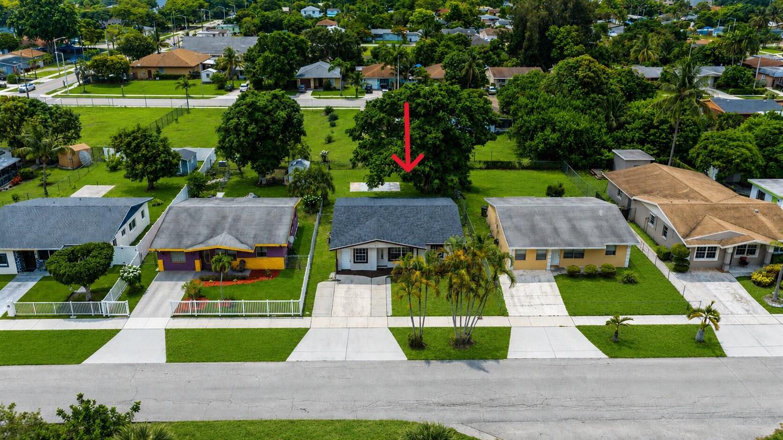 An aerial view shows a single-story house with a grey roof and a large backyard tree — 417 SW 8th Avenue, Delray Beach FL 33444, DELRAY BEACH, FL