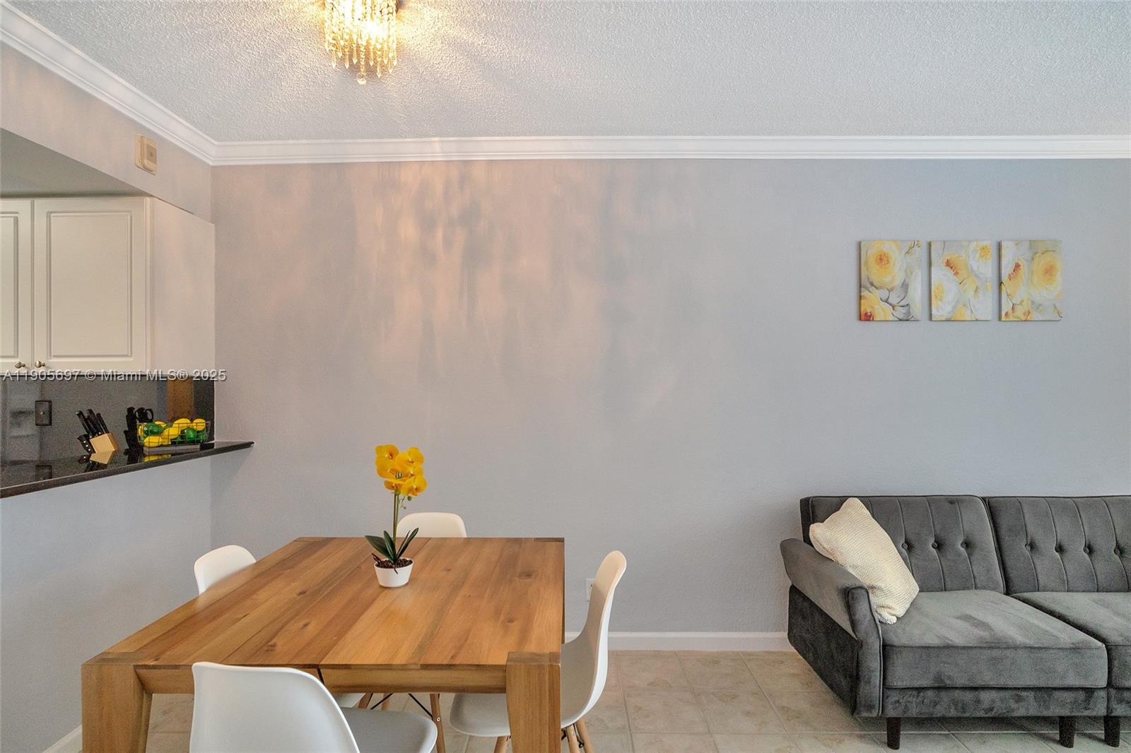 A dining area features a wooden table, white chairs, and a gray sofa nearby — 2501 S Ocean Dr # 1432, Hollywood FL 33019, HOLLYWOOD, FL