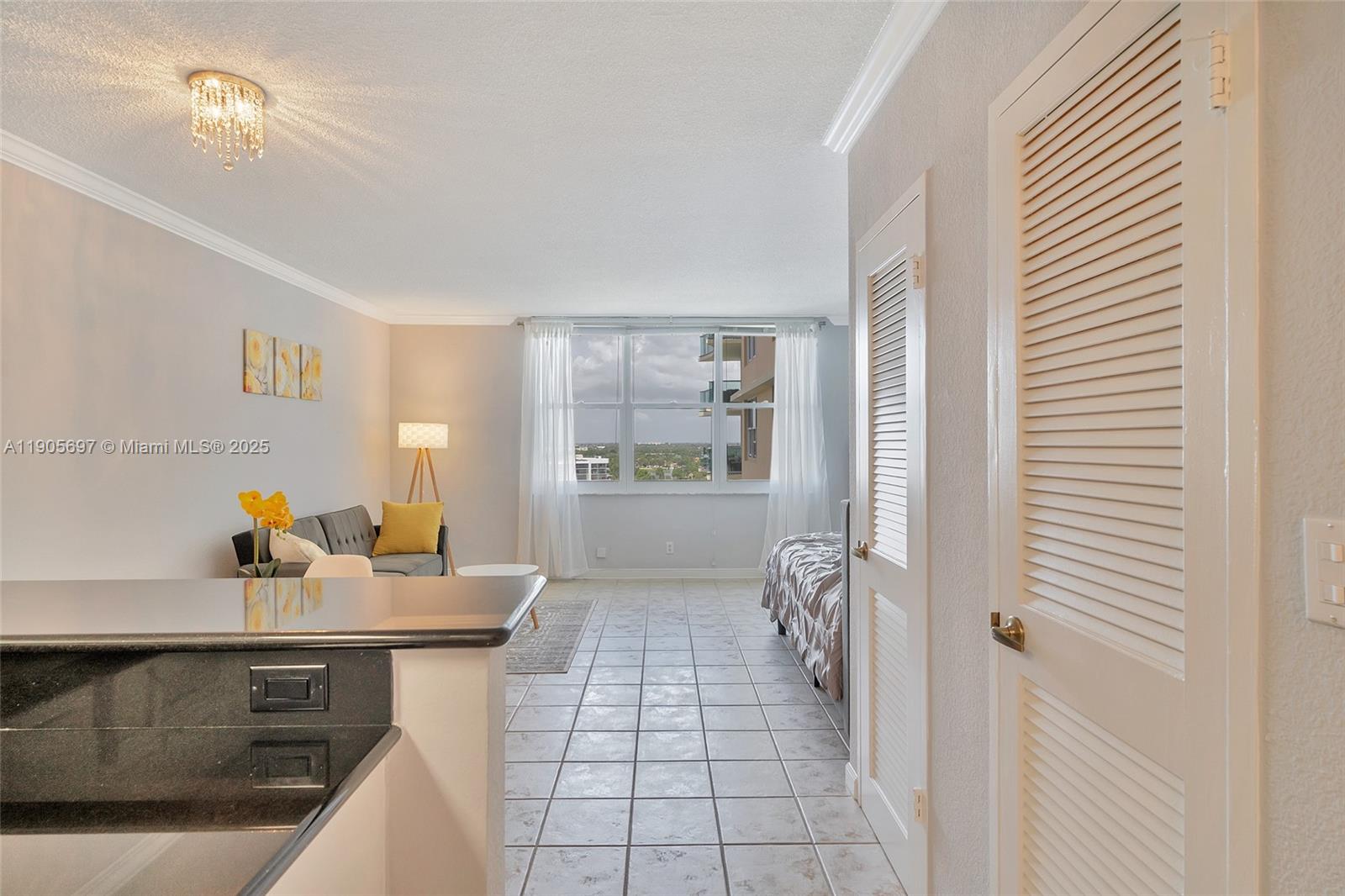 A studio apartment features a kitchen counter, living area, and bed with tile flooring — 2501 S Ocean Dr # 1432, Hollywood FL 33019, HOLLYWOOD, FL