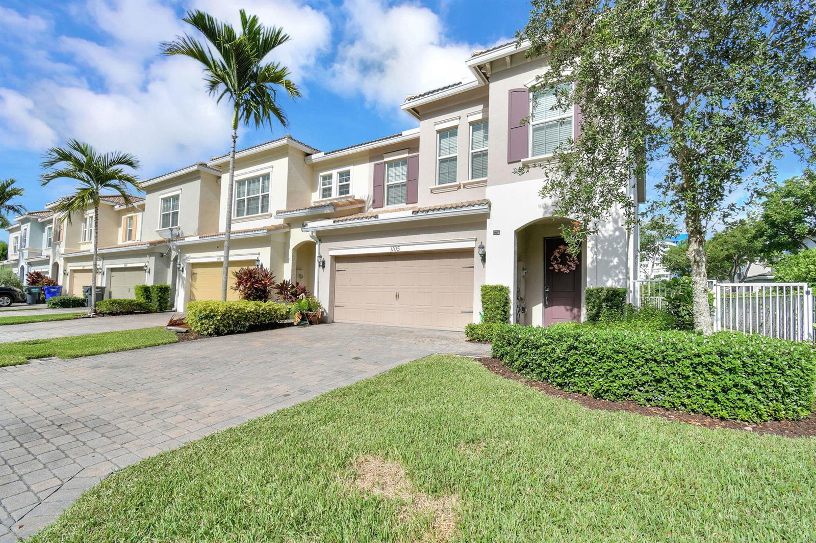 A two-story townhouse with a beige stucco exterior, a two-car garage, and a paved driveway — 1105 Banyan Drive, Hollywood FL 33021, HOLLYWOOD, FL