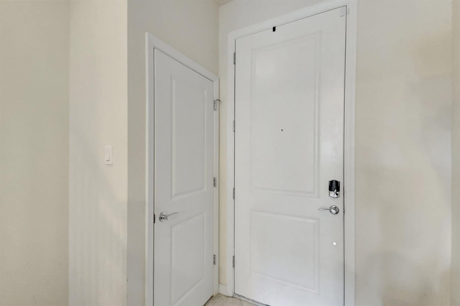 A white interior door and a taller white front door with a smart lock — 1105 Banyan Drive, Hollywood FL 33021, HOLLYWOOD, FL