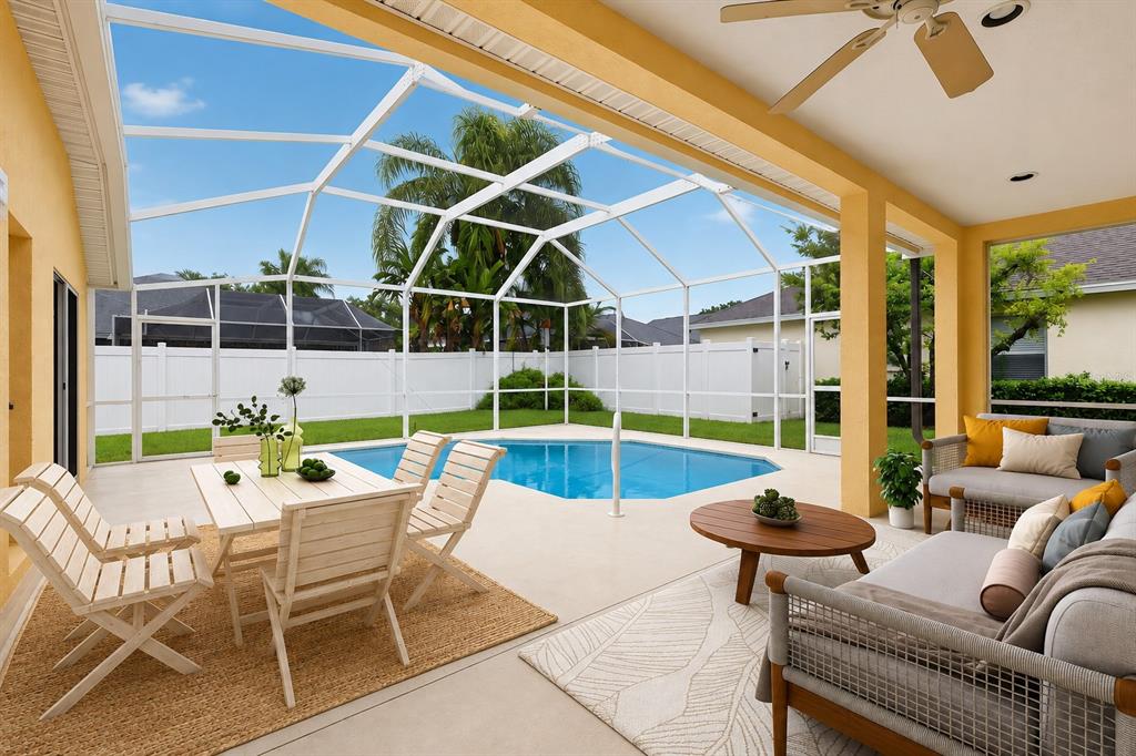 A covered patio features a swimming pool, outdoor dining set, and lounge furniture — 1549 KISH BOULEVARD, NEW PORT RICHEY, FL