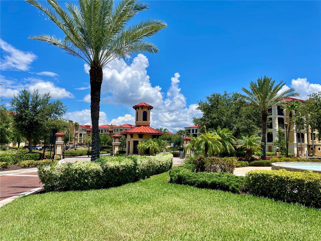 A palm tree stands in front of a small building with a red roof — 85 VIVANTE BOULEVARD UNIT 8534, PUNTA GORDA, FL
