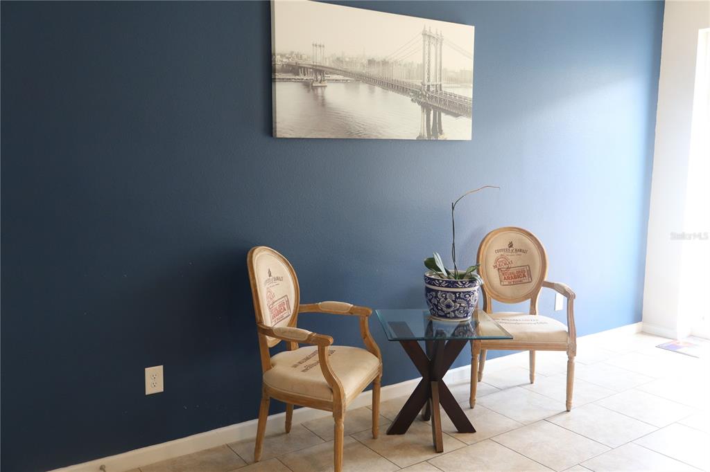 The front entrance features a dark blue door with a welcome mat and house number — 2413 GATHERING WAY, ODESSA, FL