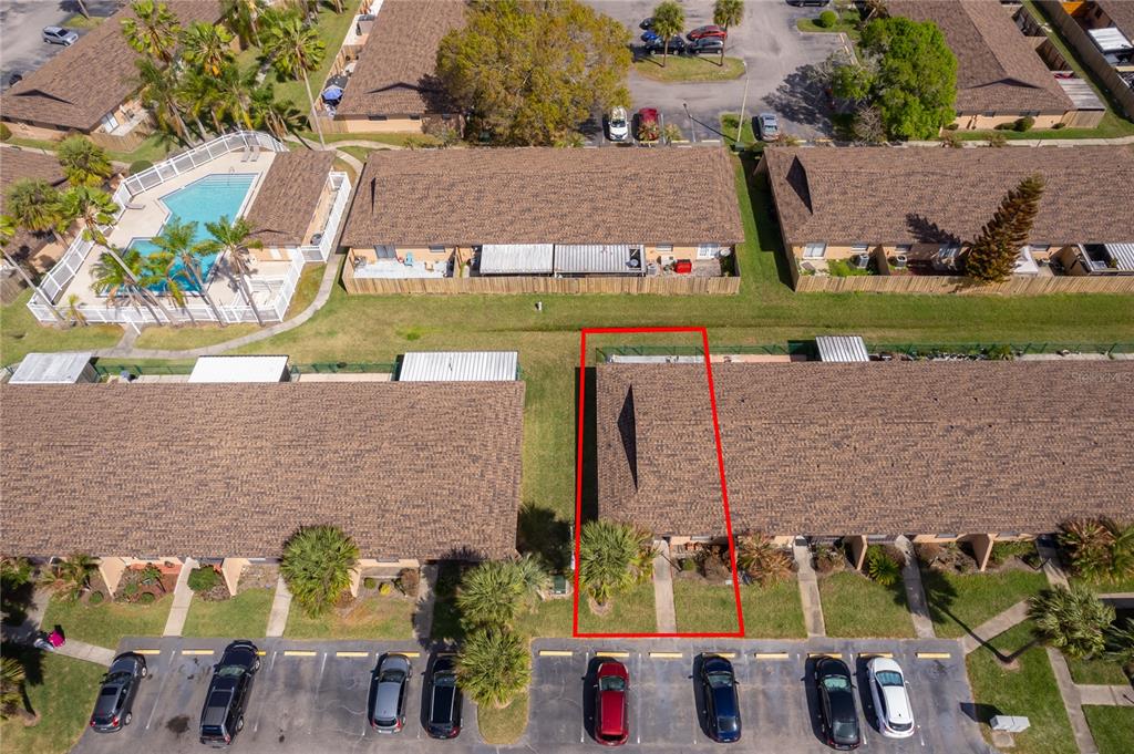 An aerial view shows a residential apartment building with a red outline highlighting one unit — 2123 ST MARTEEN COURT, KISSIMMEE, FL