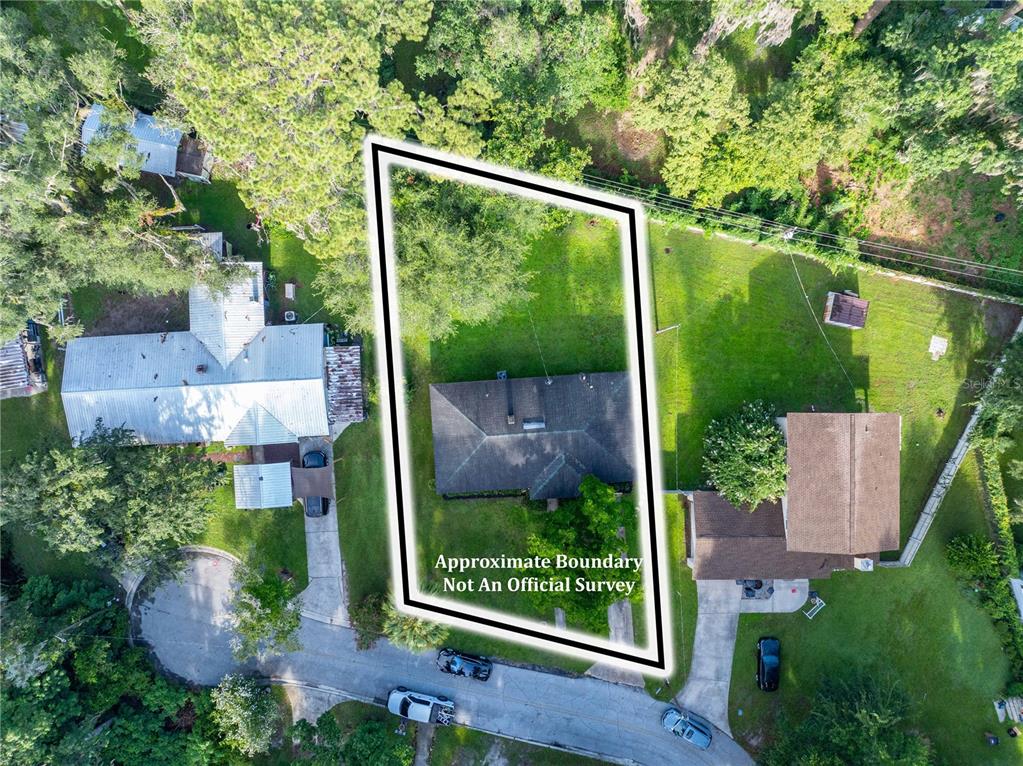 An aerial view shows a house on a lot with an outlined property boundary — 1443 SE VALE COURT, LAKE CITY, FL