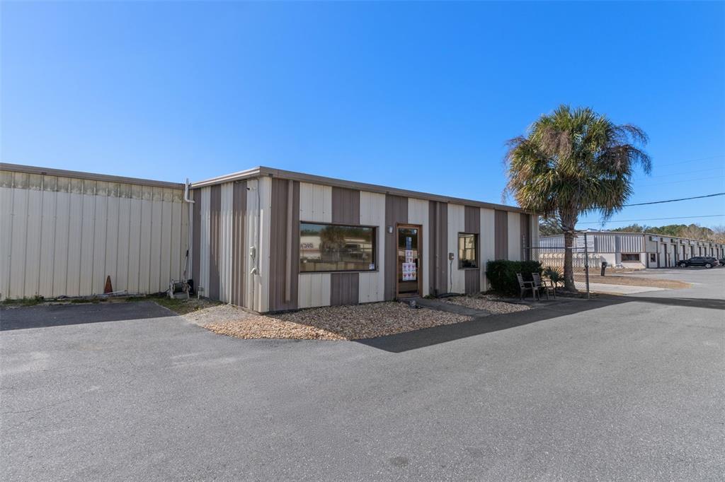 A single-story commercial building with striped metal siding sits on a paved lot — 6331 & 6275 S TEX POINT, HOMOSASSA, FL