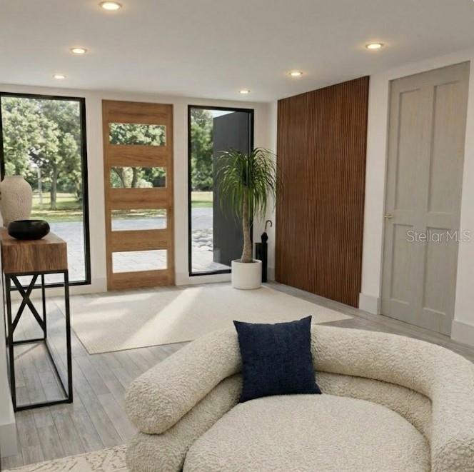 This rendering shows a modern entryway with a wood-paneled wall, glass-paneled door, and textured chair — 2408 JAMAICA AVENUE SW, PALM BAY, FL