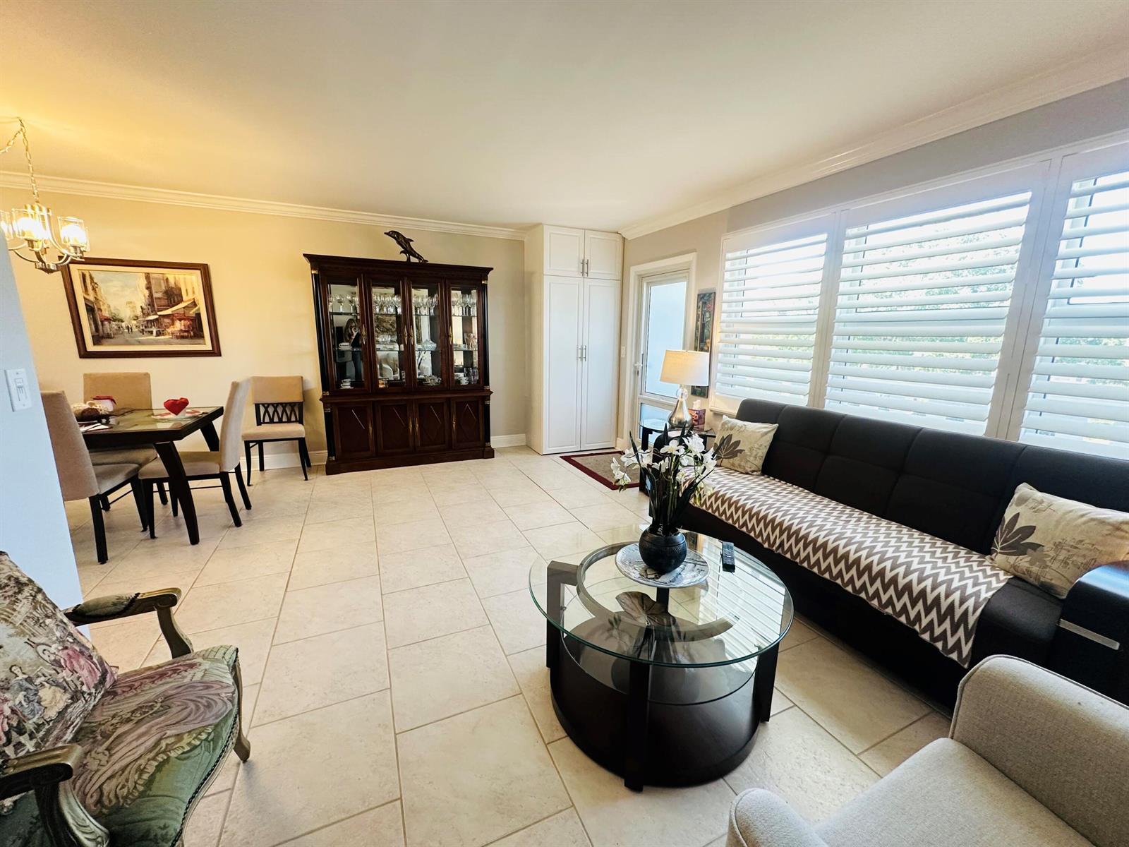 A living and dining room with tile floors, a dark wood hutch, and a sofa — 310 Grantham A # 310, Deerfield Beach FL 33442, DEERFIELD BEACH, FL