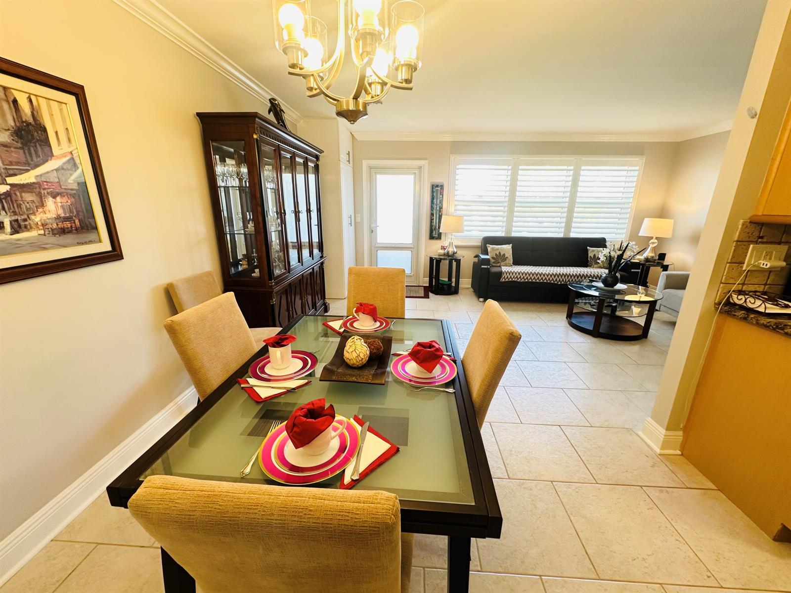 A dining area with a glass-topped table and chairs opens into a living room — 310 Grantham A # 310, Deerfield Beach FL 33442, DEERFIELD BEACH, FL