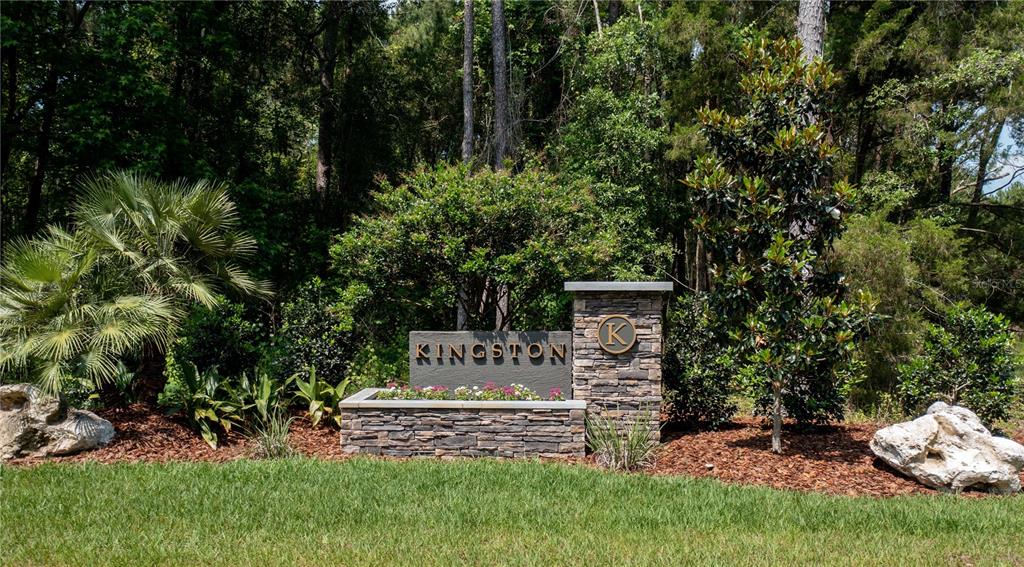 A stone monument sign for Kingston sits in a landscaped garden with trees and rocks — 2651 NW 152ND COURT, NEWBERRY, FL