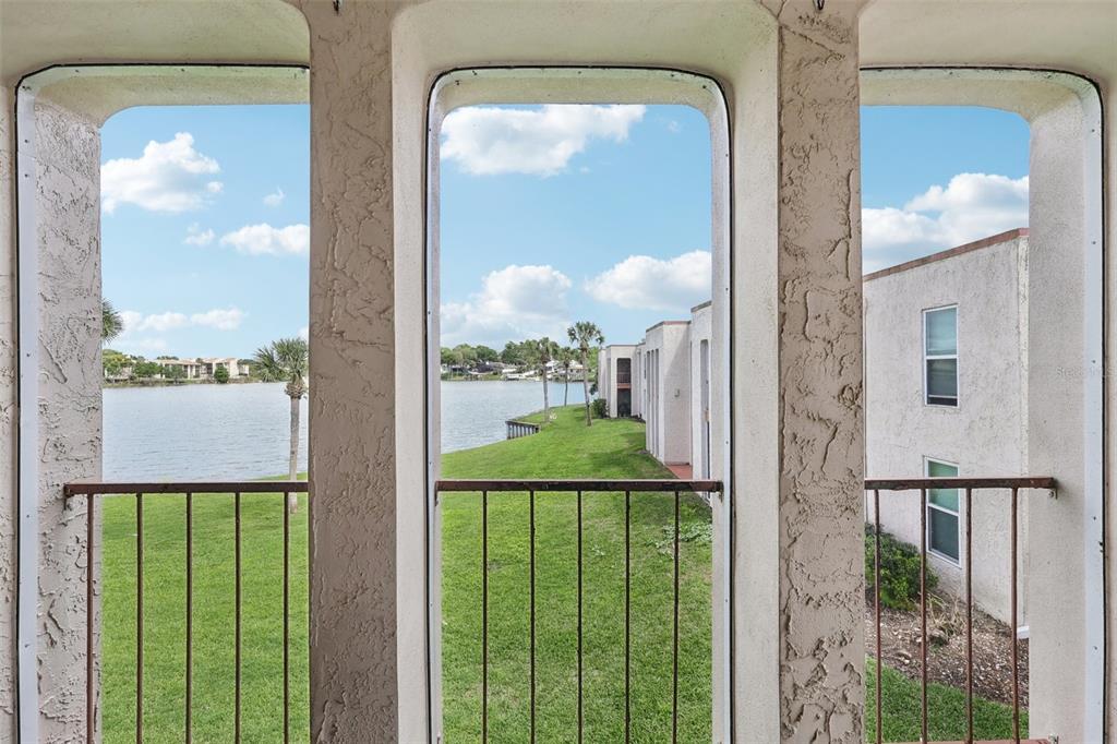 A view from a balcony looking out over a grassy lawn and a lake — 534 ORANGE DRIVE UNIT 27, ALTAMONTE SPRINGS, FL