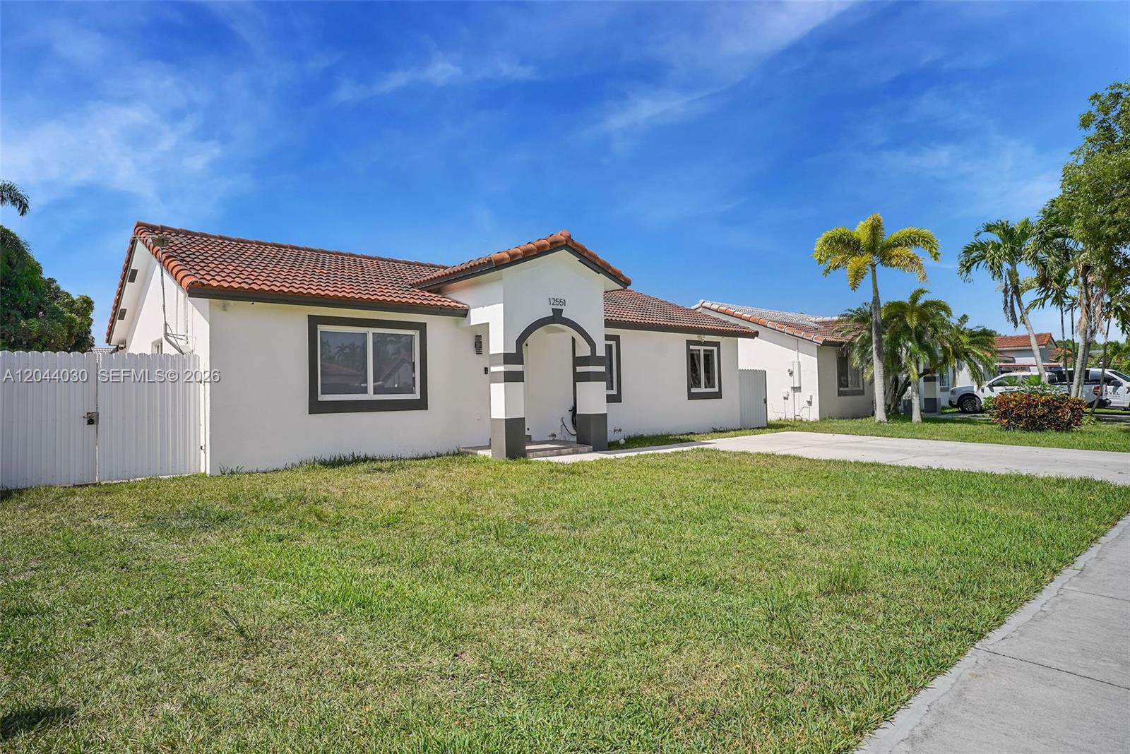 A single-story house with a white exterior, a tiled roof, and a front arched entryway — 12551 SW 223 ST, Miami FL 33170, MIAMI, FL