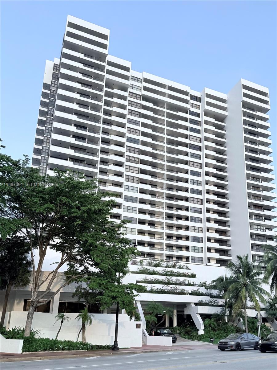 A tall white residential high-rise building with balconies and a ground-level parking structure — 2555 Collins Ave # 2112, Miami Beach FL 33140, MIAMI BEACH, FL
