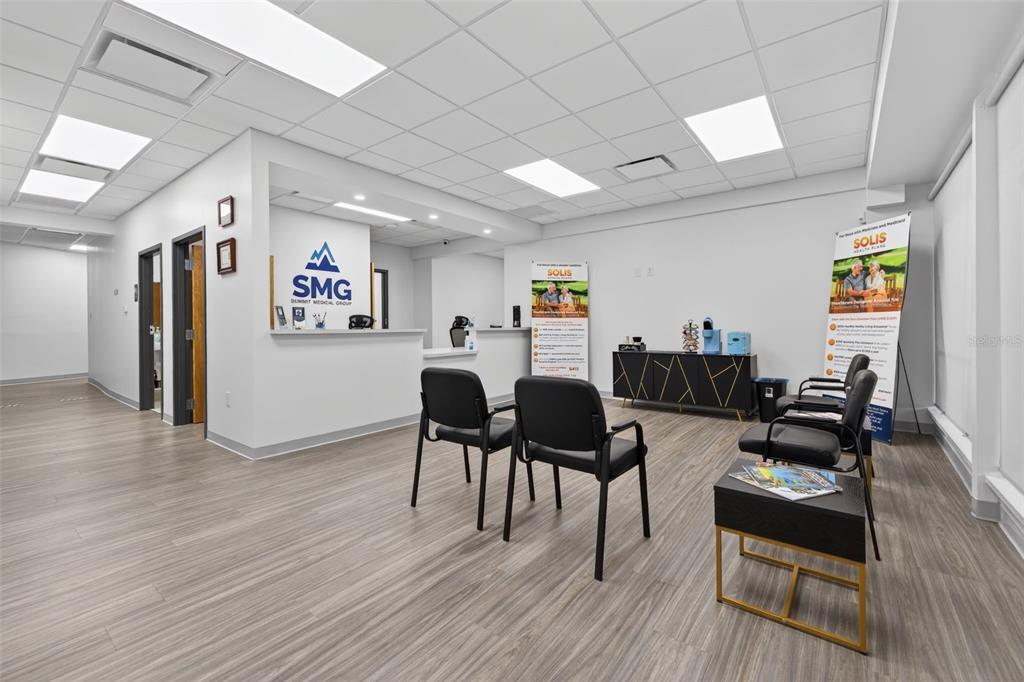 A medical office waiting room features a reception desk, chairs, and wood-look flooring — 1559 INDIAN ROCKS ROAD S, LARGO, FL