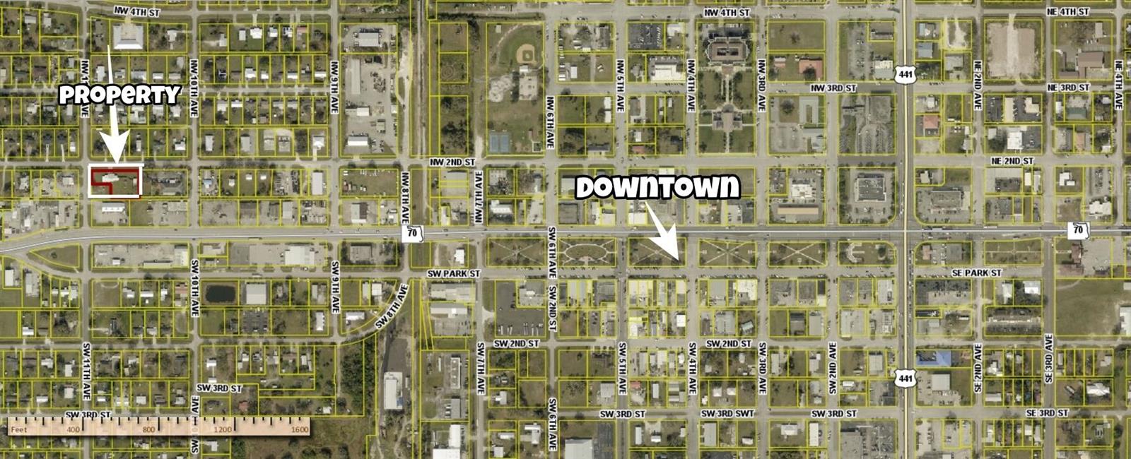 An aerial map shows a highlighted property located west of the downtown area — 1019 NW 2nd Street, Okeechobee FL 34972, OKEECHOBEE, FL