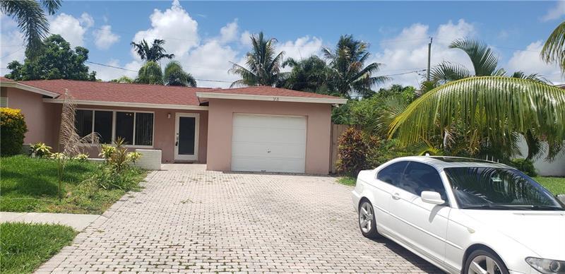 A single-story house with a red roof, white garage, and a white car in the driveway — 98 Seminole Lane, Boca Raton FL 33487, BOCA RATON, FL