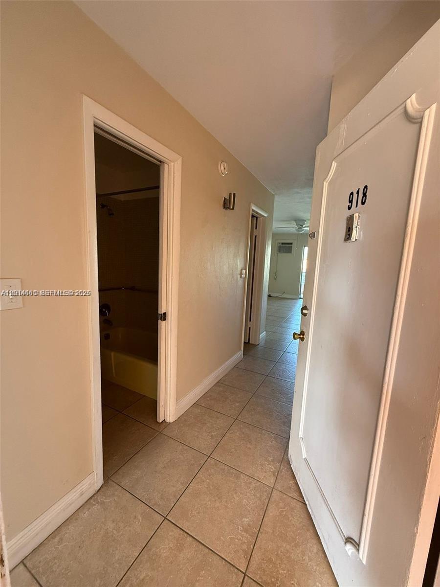 The interior view shows a tiled entryway leading to a bathroom and a living area — 18707 NE 2nd Ave # 918, Miami FL 33179, MIAMI, FL