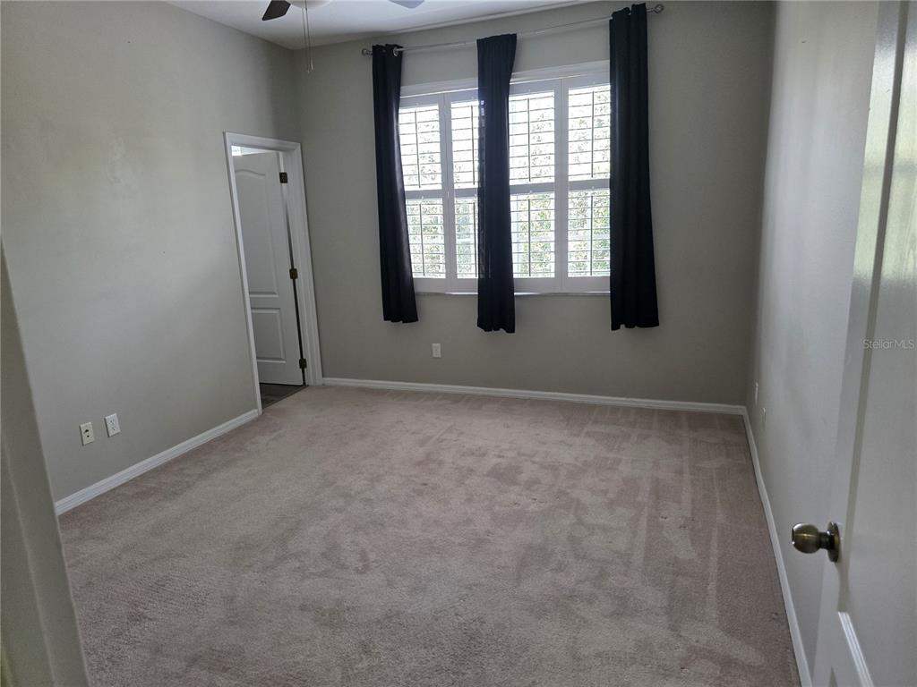 An entryway features a white staircase, wood-look flooring, and a white front door — 13551 DANIELS LANDING CIRCLE, WINTER GARDEN, FL