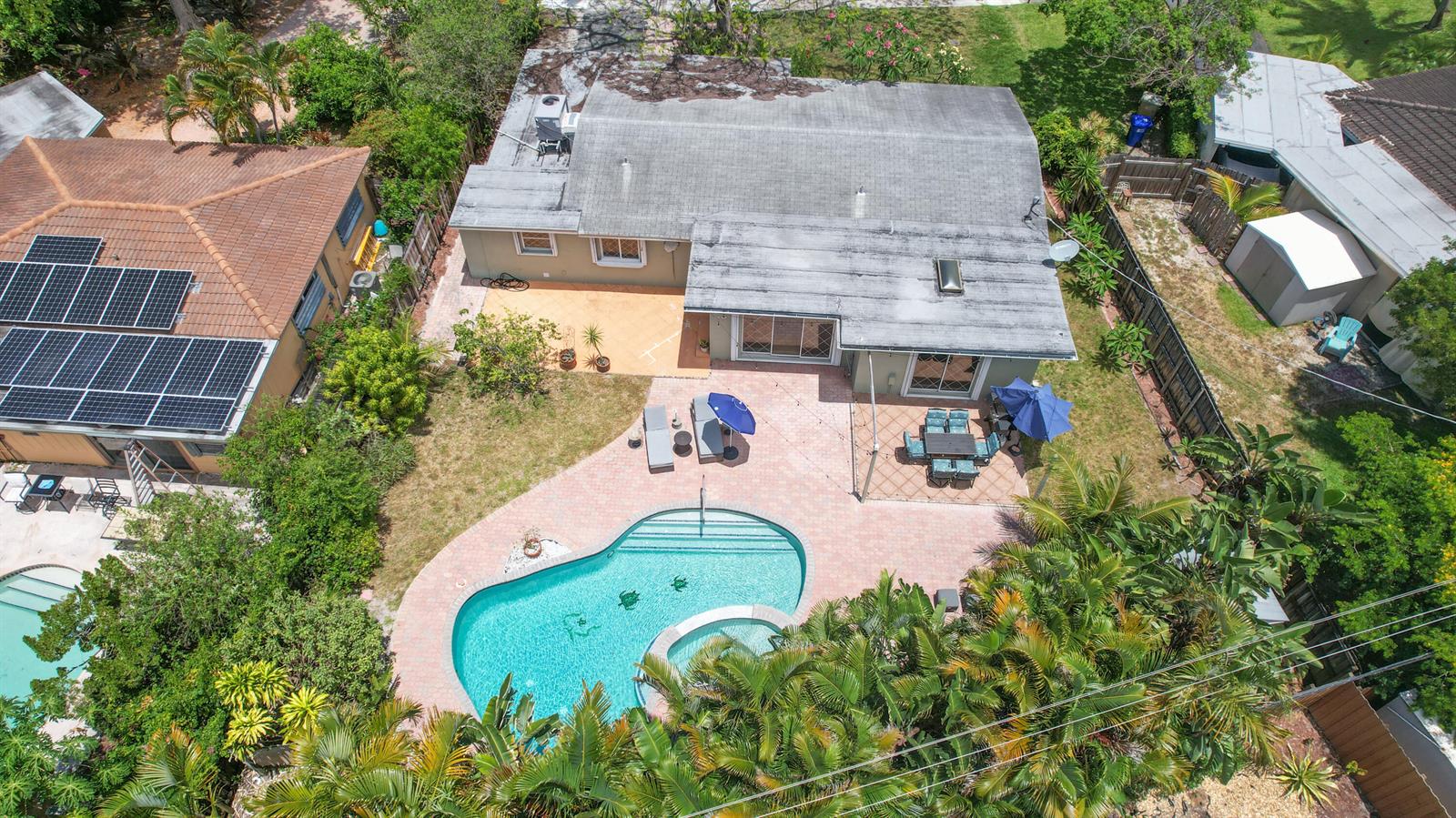 An aerial view shows a house with a pool, patio, and solar panels — 342 SW 14th Street, Pompano Beach FL 33060, POMPANO BEACH, FL