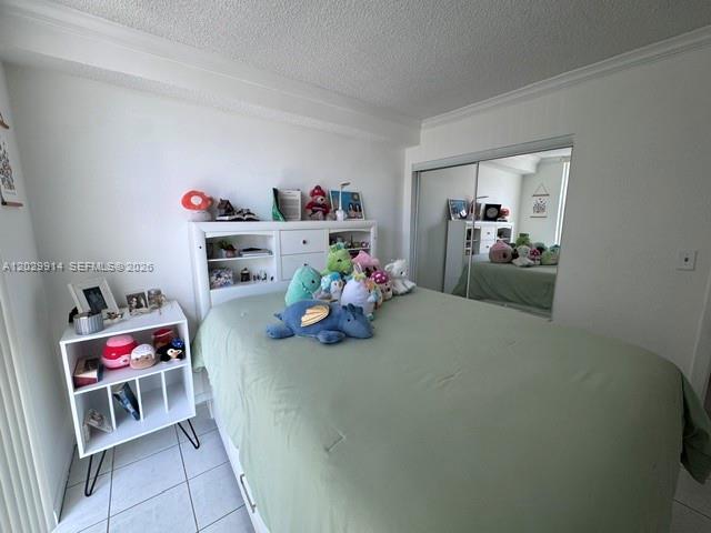 A bedroom features a bed with a green comforter, a white headboard, and a nightstand — 11780 SW 18th St # 2, Miami FL 33175, MIAMI, FL