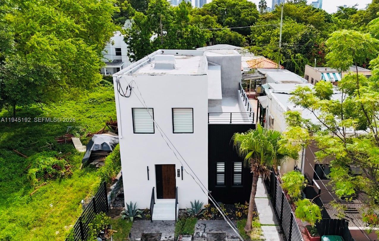 An aerial view of a modern two-story house with white and black exterior walls — 905 SW 13th Ct, Miami FL 33135, MIAMI, FL